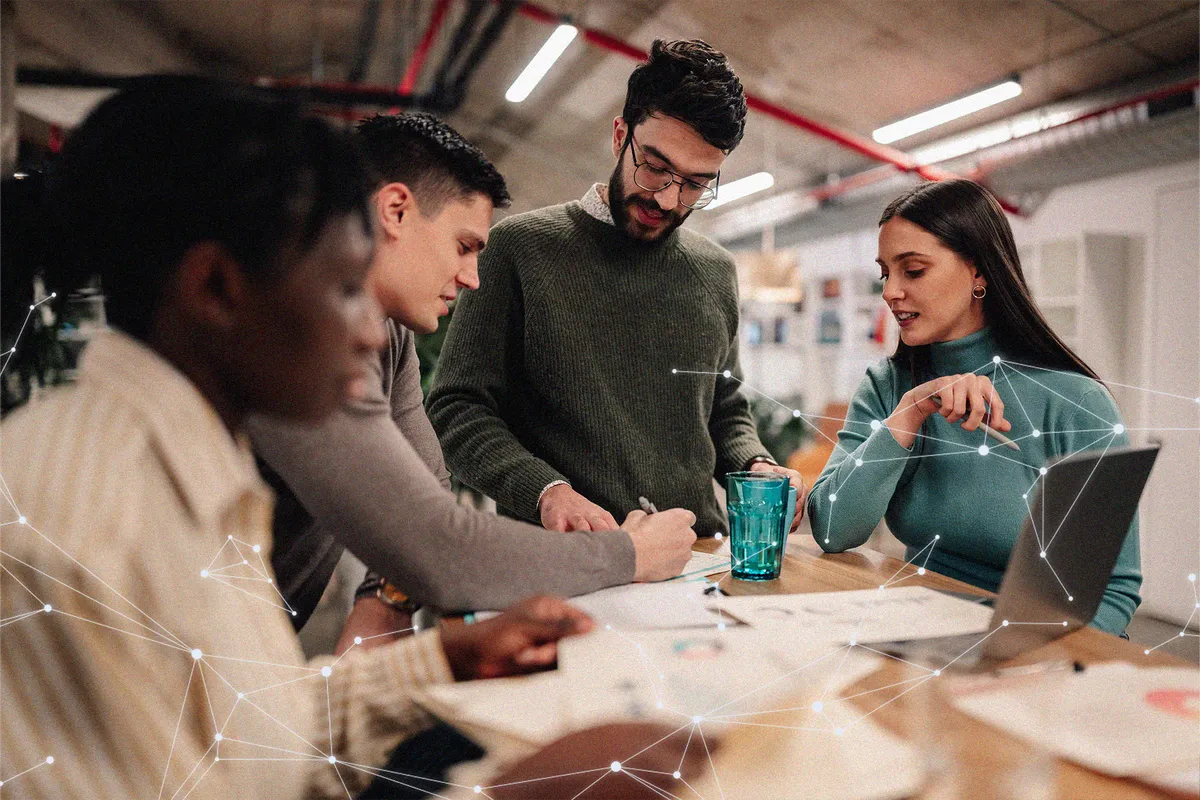 Four colleagues planning together around a table, overlaid with a network of connected points.